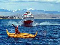 Ancient reed boat and modern hydofoil share the past and present on Lake Titicaca, Bolivia