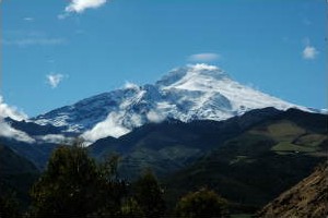 Travel through landscapes of towering volcanoes en route to Otavalo.