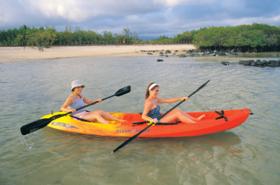 Enjoy kayaking along the white coral beach in front of the Finch Bay Eco-Hotel